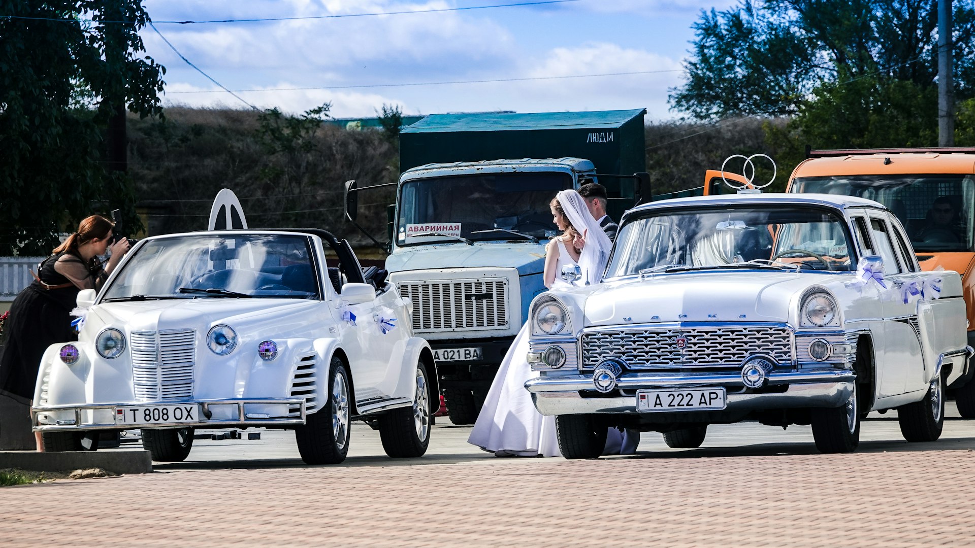 man and woman in white vintage car